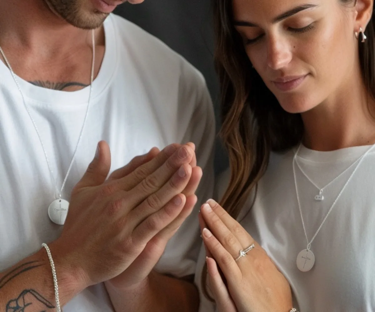 Inspirational scripture pendants on a couple, engraved with Bible quotes.